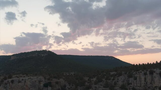 Time lapse, cloudy sky in the mountains at sunset.