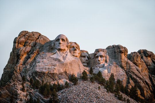 Sun Lights the Faces During an Early Morning Sunrise Over Mount Rushmore