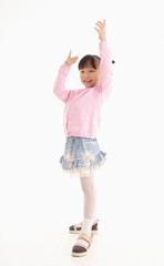 Full length of Little Asian girl standing and smiling over white background.