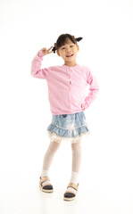 Full length of Little Asian girl standing and smiling over white background.