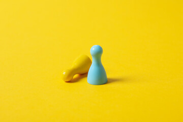 Figurines in Ukrainian flag colors on yellow background