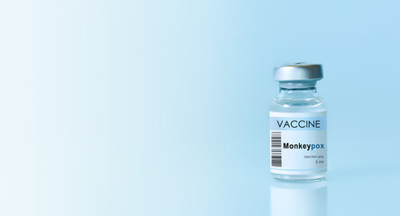 Vial with vaccine Monkeypox on a blue background.The concept of medicine, healthcare and science.Monkeypox is a viral zoonotic disease. Monkeys may harbor the virus and infect people.Copy space