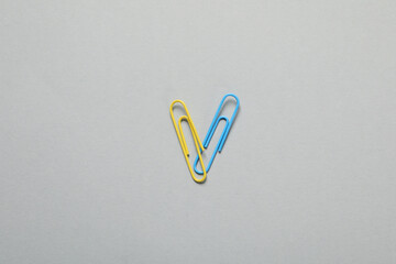 Heart made of clips in colors of Ukrainian flag on light gray background