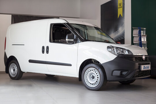 Russia, Izhevsk - August 20, 2021: Fiat showroom. New modern Doblo Cargo van in dealer showroom. Front view and side.