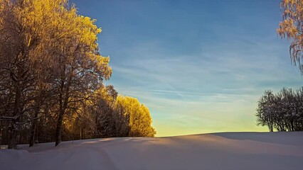 Timelapse shot of a female walking through thick layers of white snow during evening time. Cirrus clouds passing by over blue sky. - Powered by Adobe