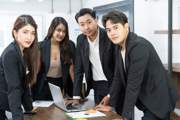 confident asian business team stands in office. happy professional multicultural office team people recommend best corporate. standing together.