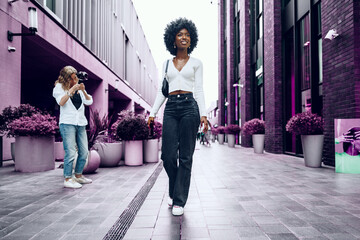 Portrait of attractive young woman walking outside in the city