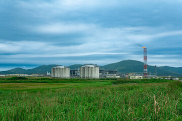plant for the production of liquefied natural gas in a natural area against the backdrop of mountains