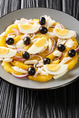 remojon granadino, salt cod orange and olive salad, spanish cuisine close-up in a plate on the table. Vertical