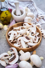 champignon mushrooms in wooden bowl at domestic kitchen