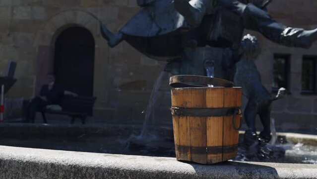 Video of the Wallenstein Festspiele in Altdorf, Bavaria's water fountain filling the wooden bucket.