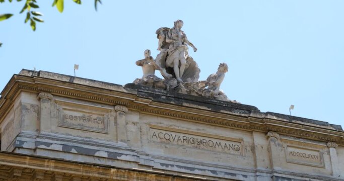 Group of statues depicting the Chariot of Venus pulled by a Triton and a Nereid on top of the Roman Aquarium building in Rome, Italy.