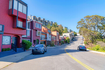 Road with double yellow lane near the row of suburban houses in San Francisco, California