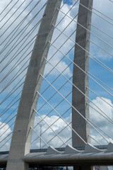 Details of Thu Thiem Two Bridge crossing the Saigon River in Ho Chi Minh City. It is the newest bridge in the economic capital. Photo features cables against sky in vertical format.
