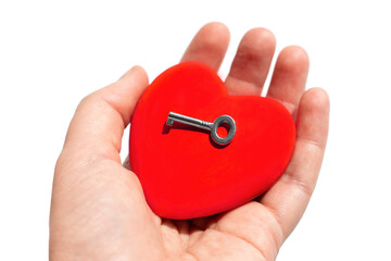 Heart shape and master key in hand on white