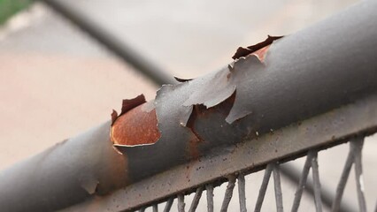 Peeled rust of corroded iron staircase handrail with cracked metal surface close up - Powered by Adobe