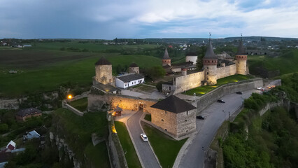 Fototapeta na wymiar View from a height of the evening medieval fortress in the city of Kamenetz-Podolsk 
