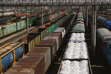 Freight wagons with mineral fertilizers at the railway station. Sending wagons for export.