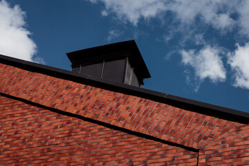 the roof of a brick house.