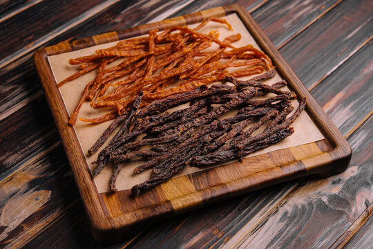 Beef and chiken jerky on wooden boadr
