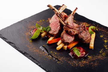 roasted lamb rack served with carrot, yellow curry and lamb sauce