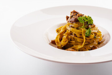 Pasta with mushrooms on white plate