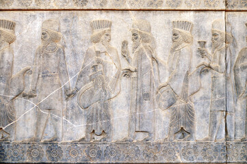 Ancient wall with bas-relief with assyrian foreign ambassadors with gifts and donations, Persepolis, Iran