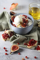 Ice cream bowl with pomegranate seeds, figs and honey