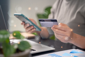 Close up shot of females hands holding credit card typing message on smart phone with technology icons for shopping online.