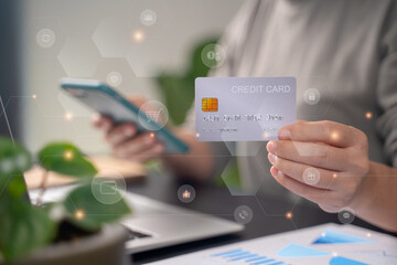 Close up shot of females hands holding credit card typing message on smart phone with technology icons for shopping online.