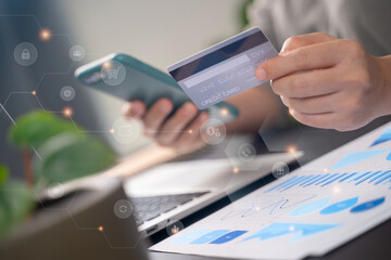 Close up shot of females hands holding credit card typing message on smart phone with technology icons for shopping online.