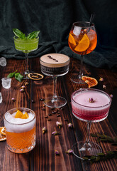 different colorful exotic alcoholic cocktails on wood