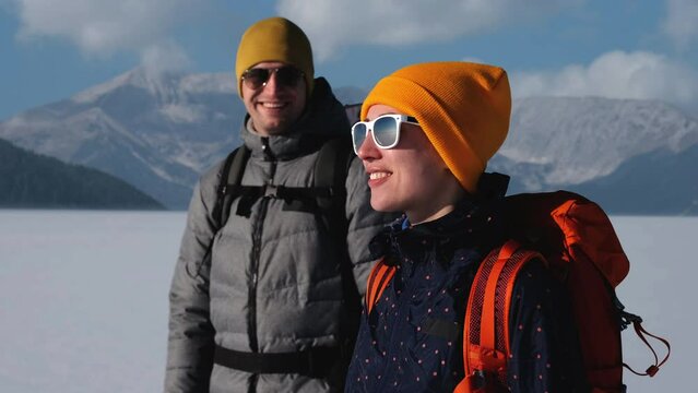 The two expeditors walking on a snowy mountains background. slow motion