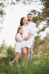 Fototapeta premium Pregnant woman with her family looking happy