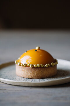 Decorated Tarlet With Peach Half On Plate