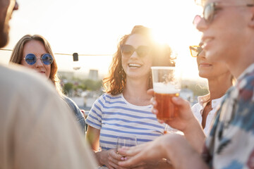 Caucasian friends talking together during the sunset