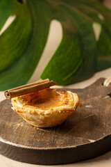 Pastel de nata, traditional Portuguese egg tart on the wooden backgrund.Close up