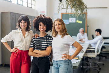 Confident multiracial businesswomen at work place
