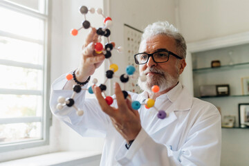 Concentrated scientist analyzing molecular structure in lab