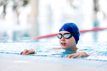 Boy in the swimming pool.  Training sessions on the water.