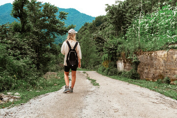 Travel. Girl travels through the mountains and waterfalls of wild nature. Unity, mental health, eco travel. Hiking in the mountains, van life vibes, travelling,good moments, digital detox