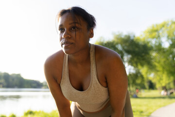 Focus African American woman preparing for workout at the park