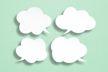 set of speech bubbles paper cut on grunge green background including clipping path. message box outline cartoon  illustration design. Balloon doodle style of thinking sign symbol