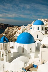 Fototapeta premium santorini churches with blue domes an white buildings blue sky and steps down white and blue greece