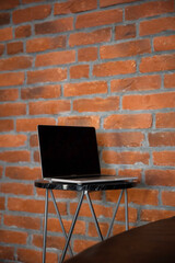 An open laptop on a coffee table. Work remotely or in the office, freelancing or remote work concept