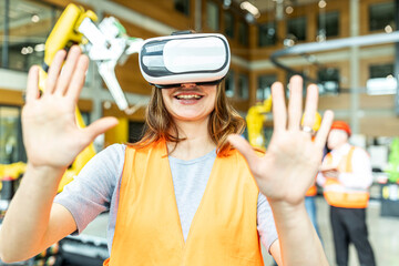 Industrial worker in robotics factory using virtual reality simulator