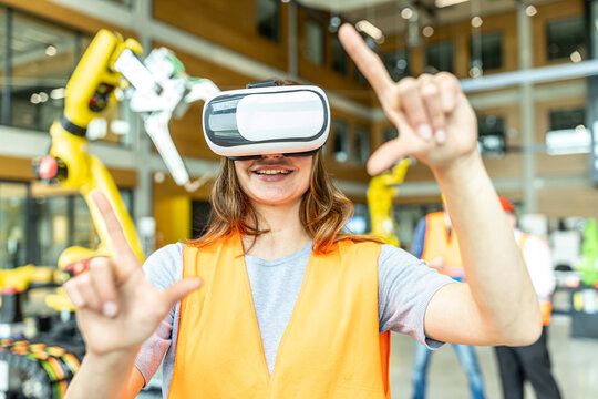 Industrial worker in robotics factory using virtual reality simulator