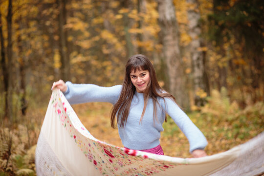 Girl dances flamenko with a shawl at the autumn park