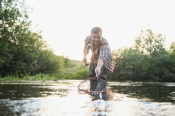 Fototapeta na wymiar Trout fishing on mountain river