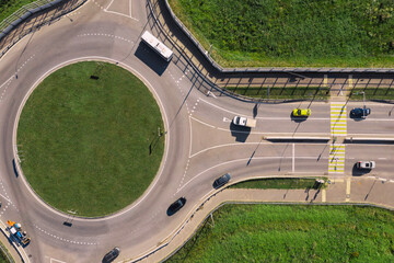 Aerial view of traffic circle amidst grass on sunny day